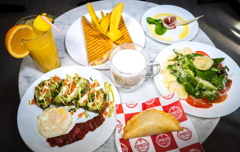 Overhead spread of Cuban breakfast dishes and drinks for a cafe, by Arte City Media