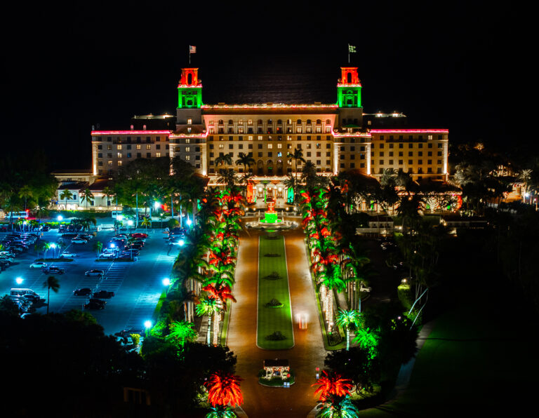 Aerial view of The Breakers resort lit up at night, by Arte City Media