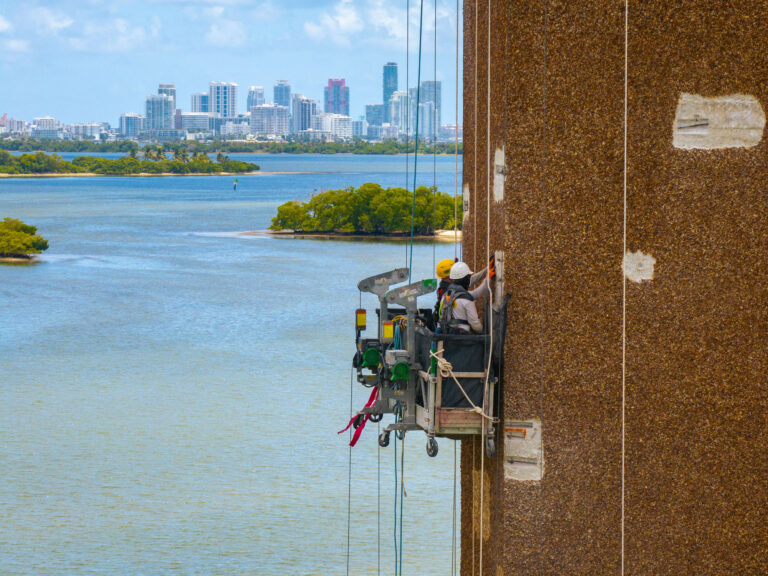 Drone view of a high-rise facade restoration on Biscayne Bay