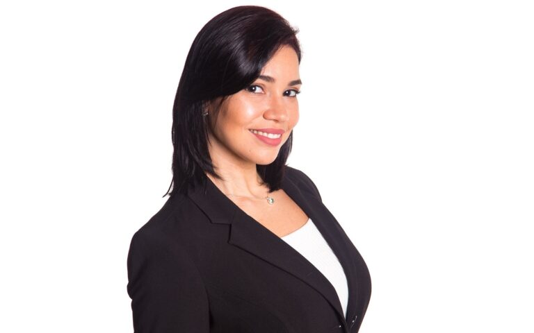 Professional corporate headshot of a woman in a black blazer