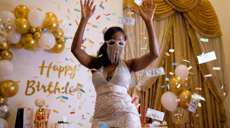 Guest celebrating at a birthday party with gold balloons, event photography by Arte City Media
