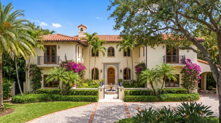 Mediterranean Spanish-style home in Coral Gables with a red tile roof, palms and bougainvillea, real estate photography by Arte City Media