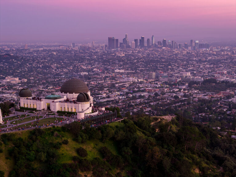 Aerial view of Griffith Observatory and the Los Angeles skyline at dusk, by Arte City Media