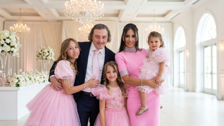 Family portrait of parents and three daughters in pink in an elegant white ballroom, by Arte City Media
