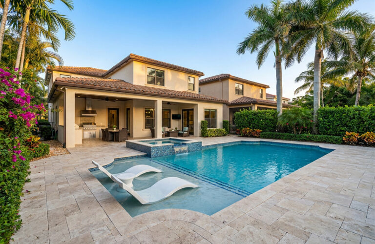 Luxury home with a pool, spa and travertine deck surrounded by palms, by Arte City Media