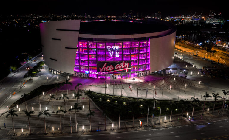 Aerial view of the arena glowing pink with the Vice City sign at night, Miami, by Arte City Media